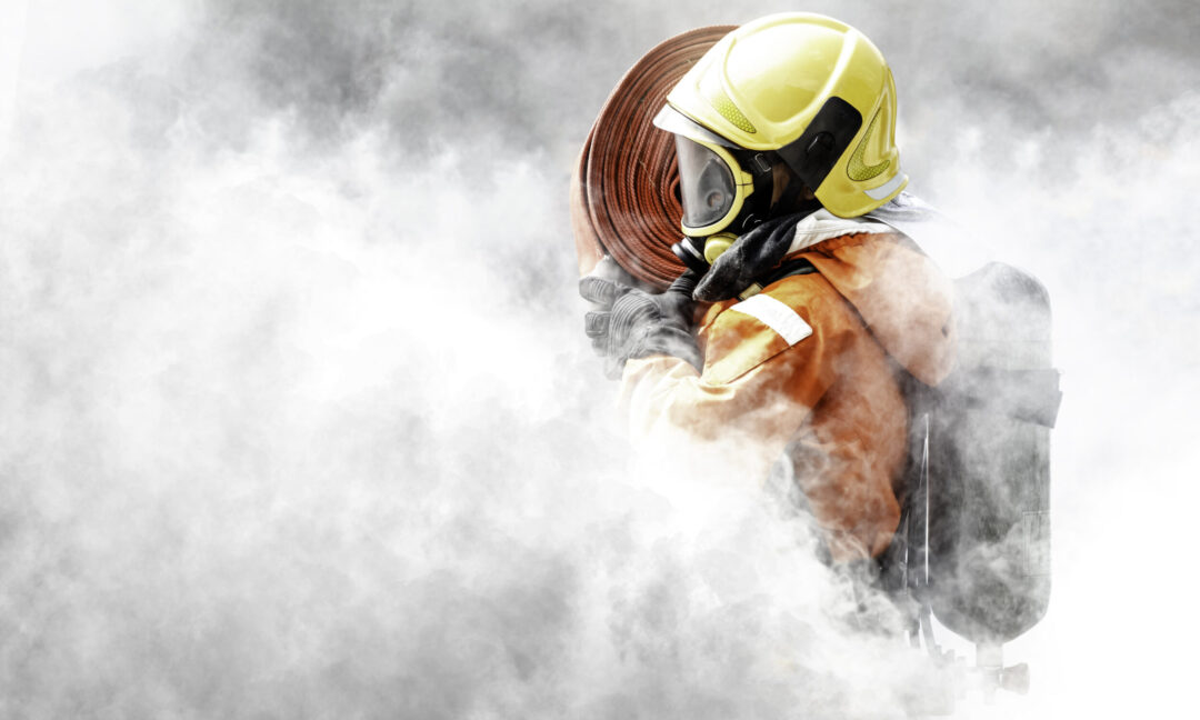 Firefighter In The Midst Of Fire And Smoke.
